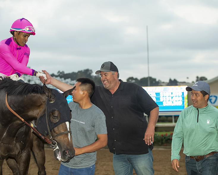 Craig Dollase and his team greeting a winning horse